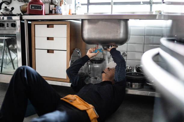 Pumber fixing water pipe under the sink